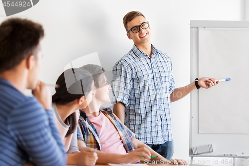 Image of group of high school students with flip chart