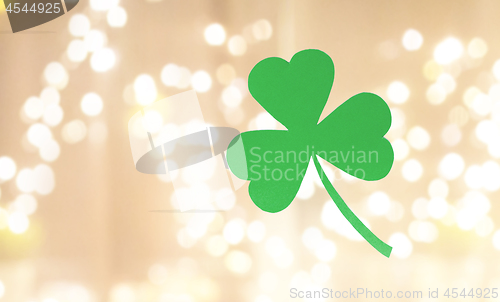 Image of green paper shamrock over festive lights