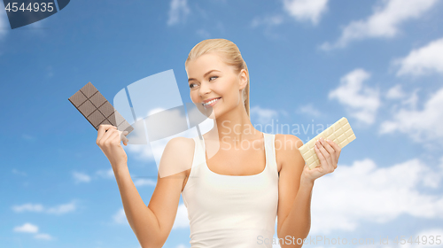 Image of woman choosing between dark and white chocolate