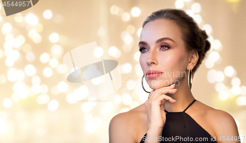 Image of beautiful woman in black wearing diamond jewelry