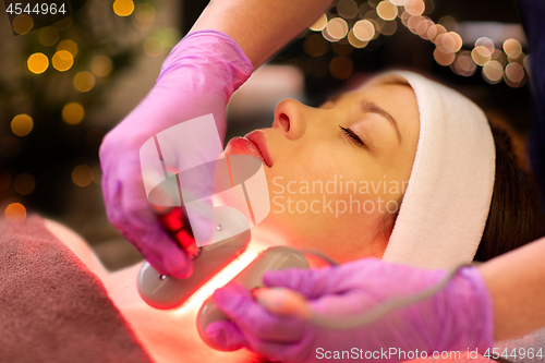 Image of young woman having face microdermabrasion at spa