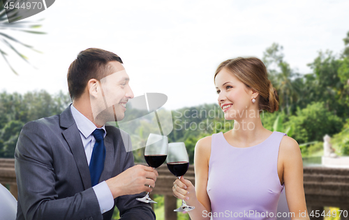 Image of young couple with glasses of wine at restaurant