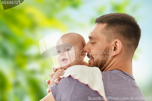 Image of father with little baby over natural background