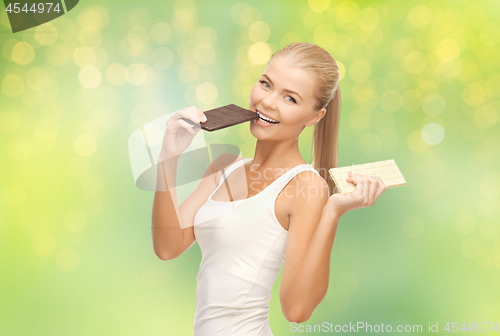 Image of happy woman eating dark chocolate instead of white