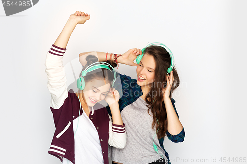 Image of teenage girls in earphones listening to music