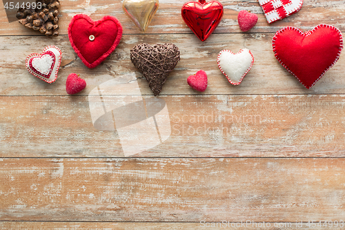 Image of heart shaped decorations on wooden background