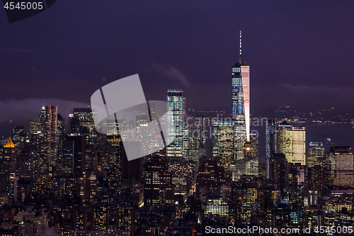 Image of New York City skyline with lower Manhattan skyscrapers in storm at night.