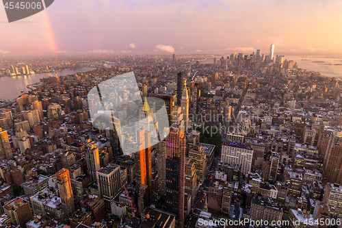 Image of New York City skyline with Manhattan skyscrapers at dramatic stormy sunset, USA.