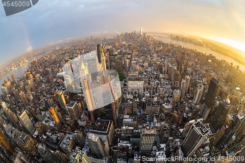 Image of New York City skyline with Manhattan skyscrapers at dramatic stormy sunset, USA