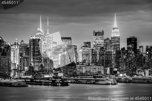 Image of West New York City midtown Manhattan skyline view from Boulevard East Old Glory Park over Hudson River at dusk.