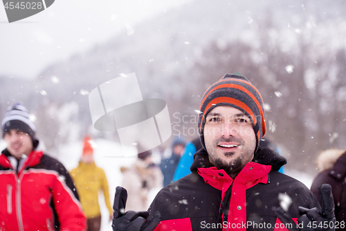 Image of portrait of young man in beautiful winter landscape