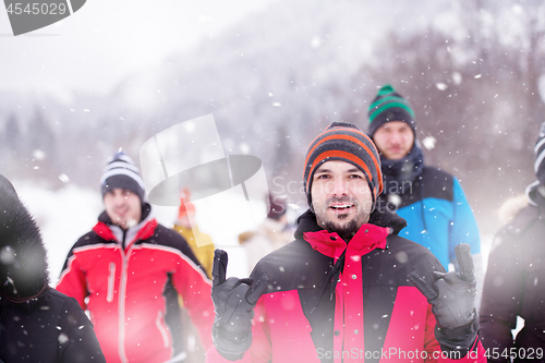 Image of portrait of young man in beautiful winter landscape