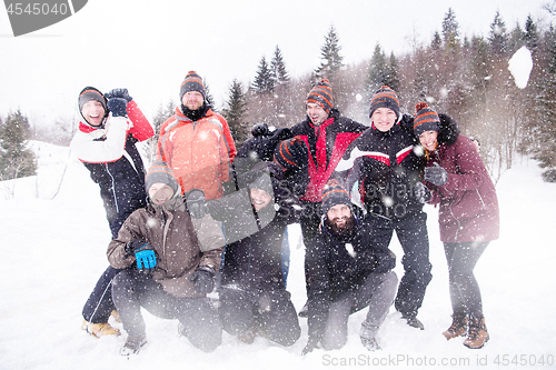 Image of group of young people throwing snow in the air