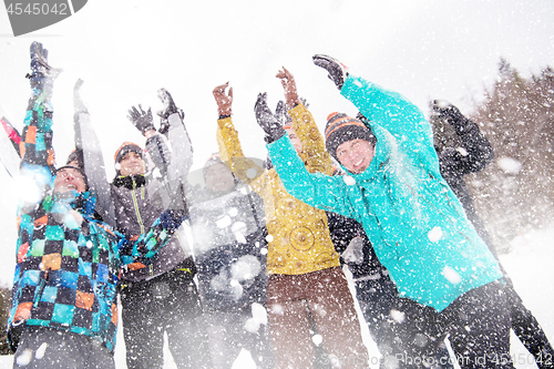 Image of group of young people throwing snow in the air