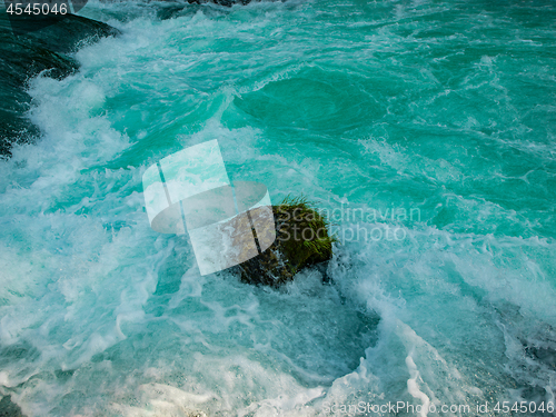 Image of single stone in wild river