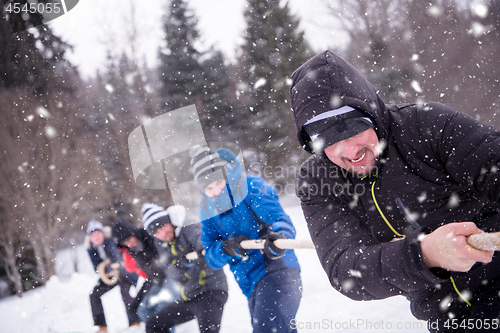 Image of group of young people pulling a rope in tug of war competition