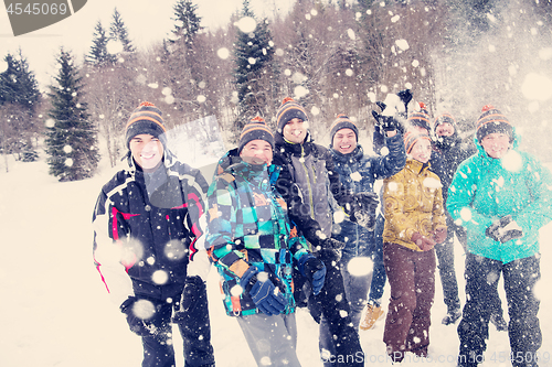 Image of group of young people throwing snow in the air