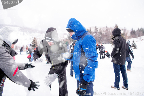 Image of group of young people making a snowman