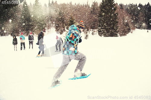 Image of group of young people having a running competition on winter day