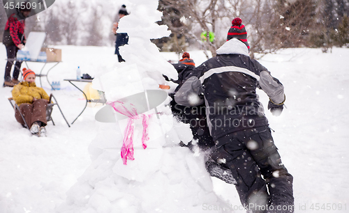 Image of group of young people having fun in beautiful winter landscape