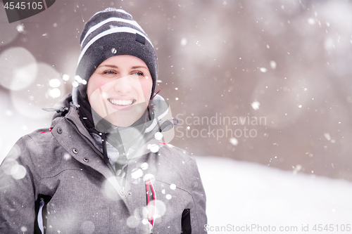 Image of Portrait of young woman on snowy winter day