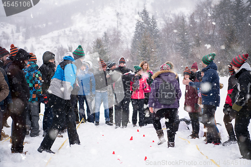 Image of group of young people having blindfolded games competition