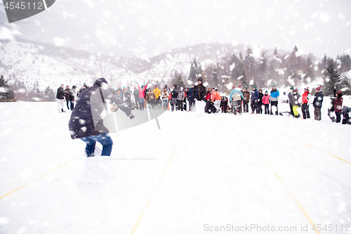 Image of group of young people having a running in bag competition