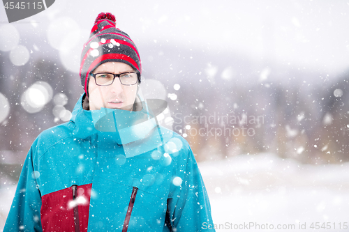 Image of Portrait of young man on snowy winter day