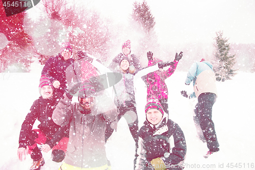 Image of group of young people throwing snow in the air