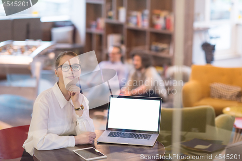 Image of businesswoman using a laptop in startup office