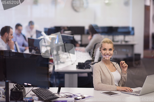 Image of businesswoman using a laptop in startup office