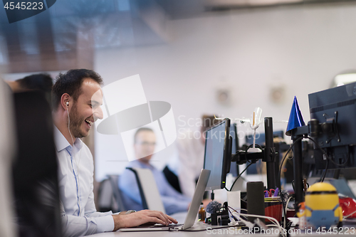 Image of businessman working using a laptop in startup office