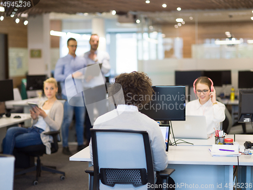 Image of businessman working using a laptop in startup office