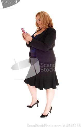 Image of Big business woman texting on her cell phone