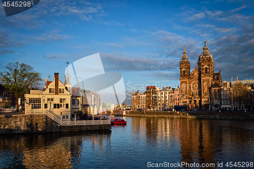 Image of Amsterdam canal and Church of Saint Nicholas on sunset