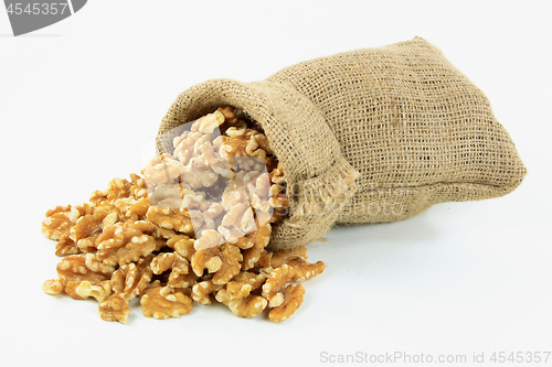 Image of Spilled on white Walnuts. 