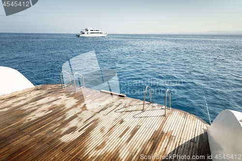 Image of Wet boat deck against blue ocean