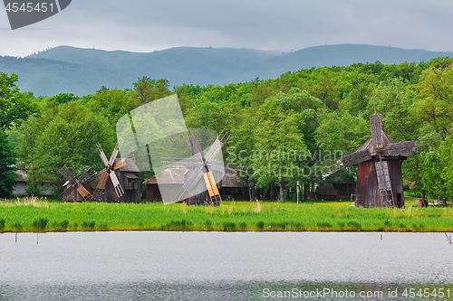 Image of Windmills on the Bank of Lake