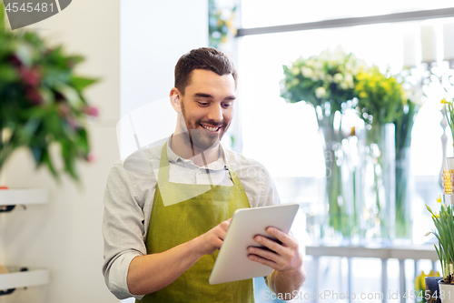 Image of man with tablet pc computer at flower shop