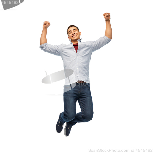 Image of happy young man jumping over white background