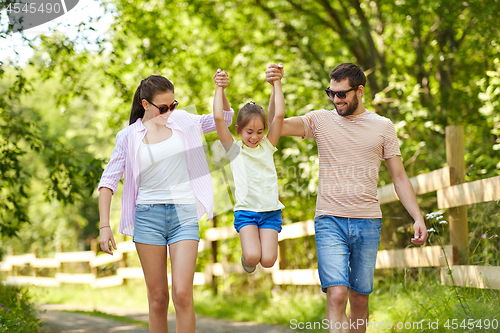 Image of happy family walking in summer park