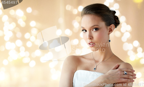 Image of beautiful woman with earring, ring and pendant