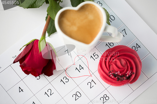 Image of close up of calendar, coffee, cupcake and red rose