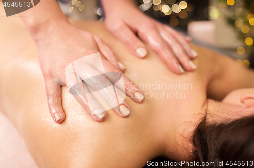 Image of close up of woman having back massage at spa