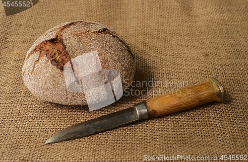 Image of traditional finnish rye bread on burlap and finnish knife puukko