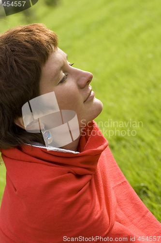 Image of woman sitting on the grass