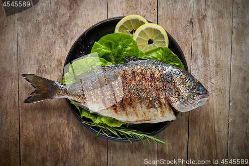 Image of Grilled fish on black plate