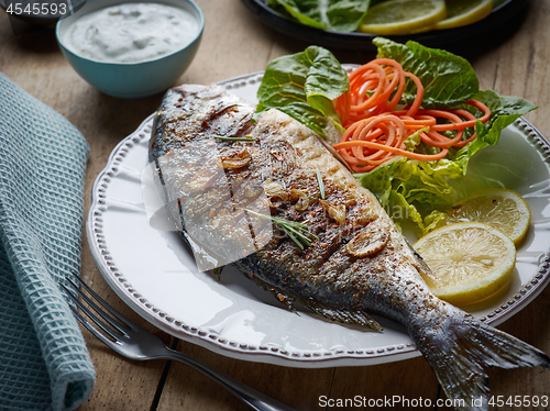 Image of grilled fish on wooden kitchen table