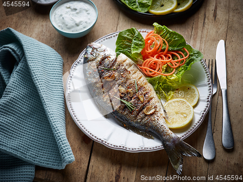 Image of grilled fish on wooden kitchen table