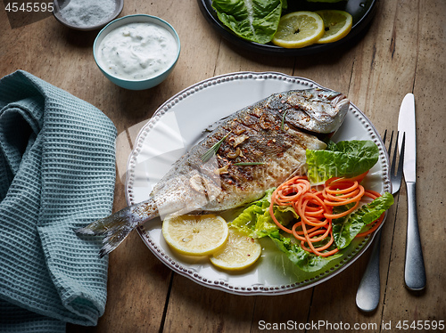 Image of grilled fish on wooden kitchen table